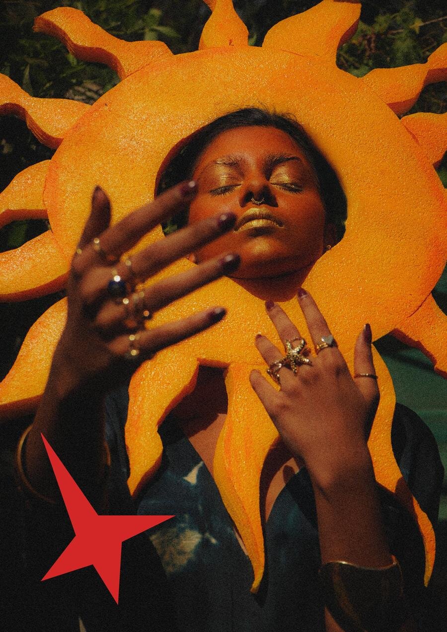 Model in a foam sun headpiece with starfish rings